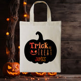 A Personalised Trick or Treat Tote 100% Cotton Canvas Bag for Children. Featuring a Giant Pumpkin Silhouette inset with the bold orange words "Trick or Treat" in spooky lettering, a small pumpkin grin face with the name James underneath.